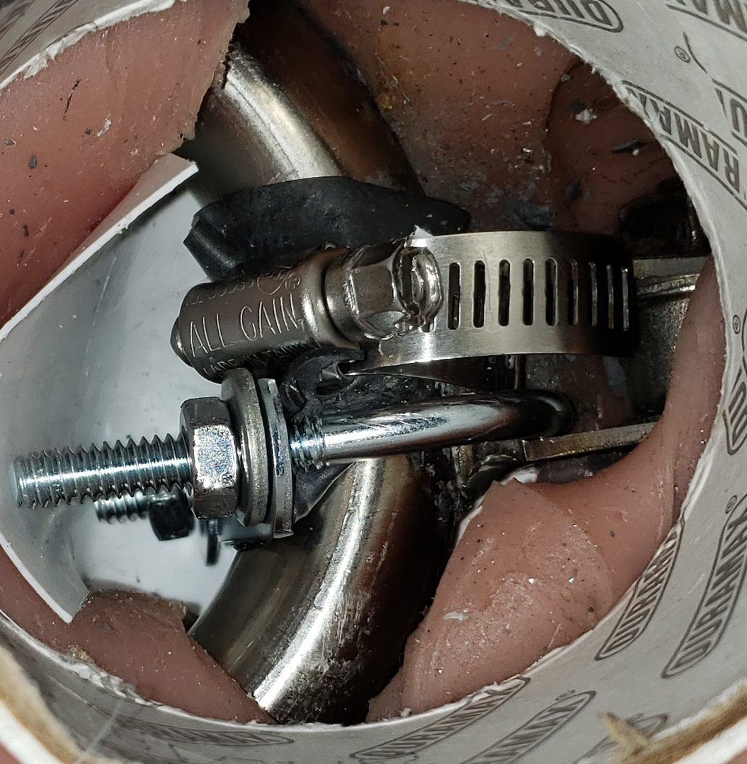 U-bolt added to the connection to give more strength. Takes a lot of time to make it fit. Note the white plastic from a yogurt pot placed between the TPE and the skeleton. It helps the clamp and bolt slide through the hole in the upper skeleton frame, and the hip tube.